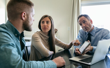 Couple Discusses Financial Information On Tablet