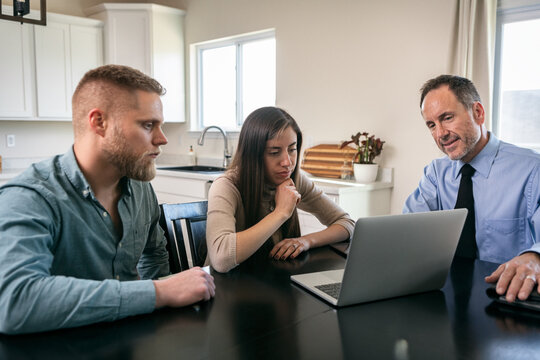 Couple Thinking About Financial Information On Laptop