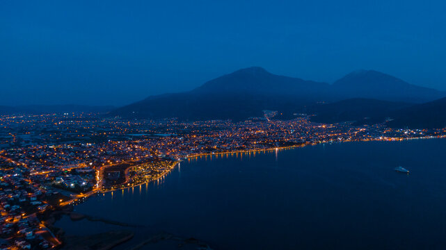 night cityscape of Fethyie, misty mountains  behind
