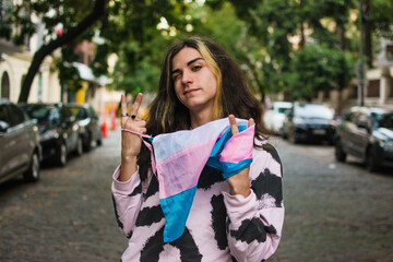 Cool trans girl winking with pride flag portrait