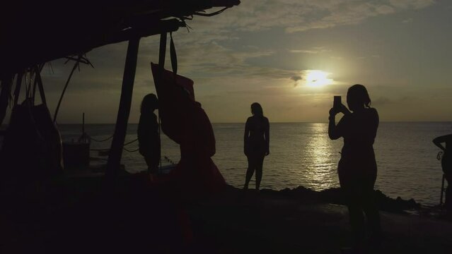 girls taking photos at sunset in san andres island