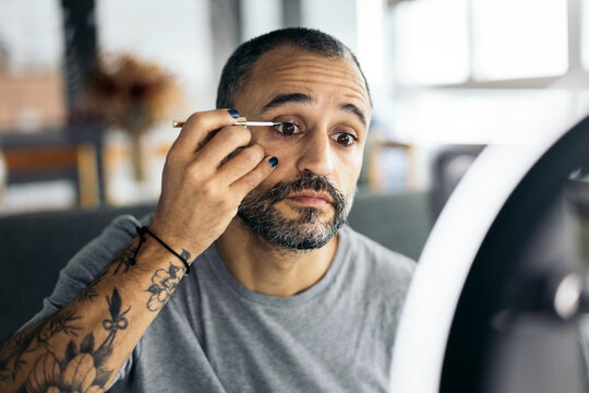 tattooed Man Putting On Makeup