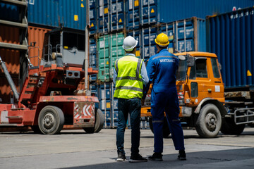 Foremans are discussing for stack container at cargo site logistics service transportation. Import export concept.