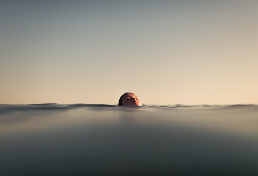 Surreal portrait of woman floating on the sea asleep