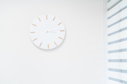 White Clock In White Wall Background