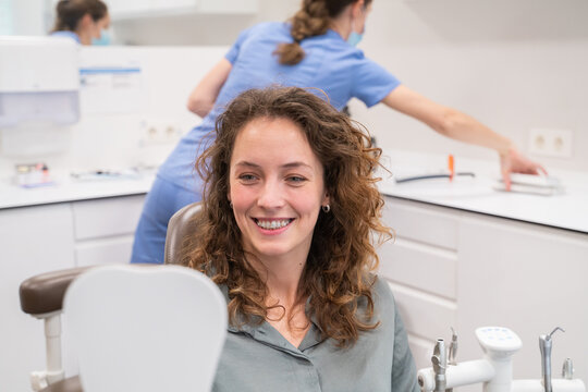 Patient With Ceramic Braces Looking The Mirror
