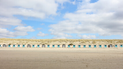 row of beach cabins near the dunes