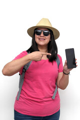 Latin adult woman with sunglasses, hat and pink shirt uses her cell phone to locate herself on a map app as a tourist while discovering a new place on vacation	