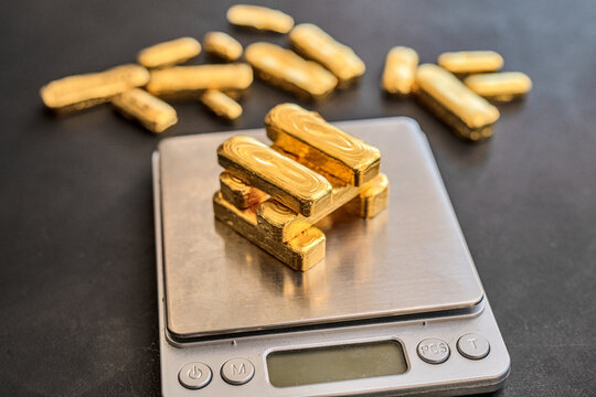24 carat gold bars on scales