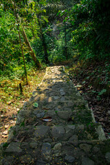 A steep staircase made of cement and stone that sits on a mountain cliff