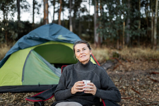 mature woman with a cup of coffee in nature