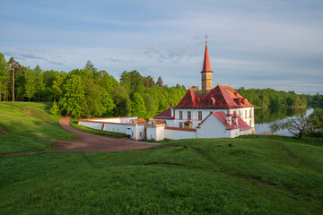View of the Priory Palace on the shore of the Black Lake on an summer sunny morning, Gatchina, St. Petersburg, Russia