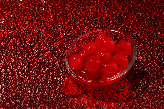 glass bowl with some maraschino cherries