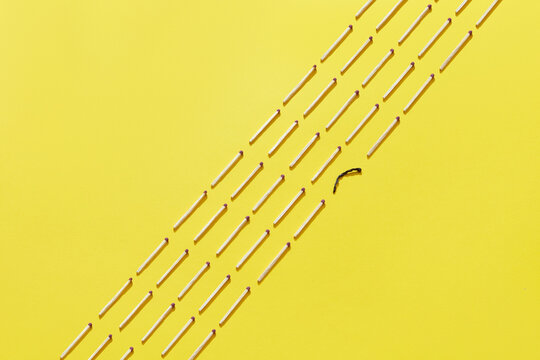 Rows of matches and one burnt match