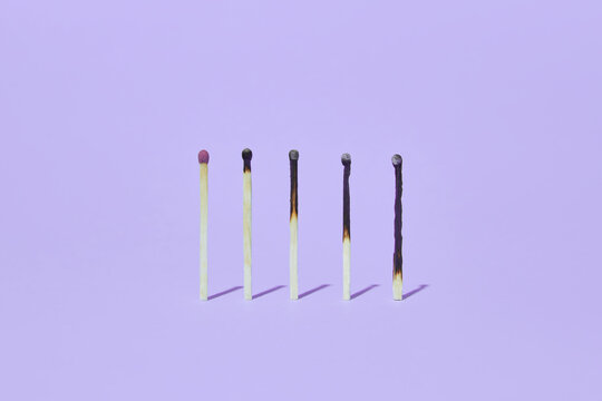 Burnt matches on violet background
