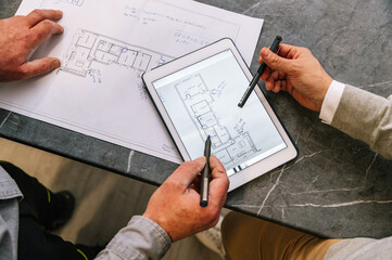 Crop architects examining draft on tablet