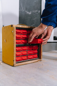 Crop worker taking box from tool organizer