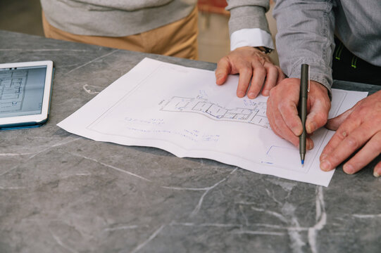 Crop architects discussing apartment plans