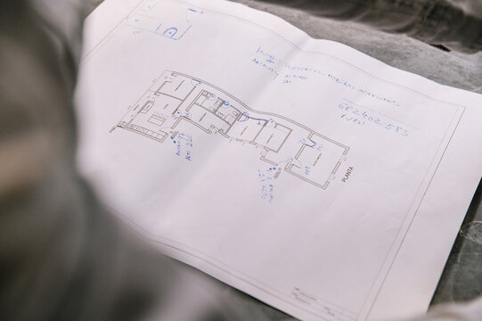 Crop architects discussing apartment plans