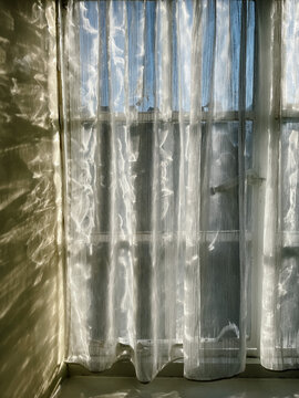 Sunlight through a net curtain