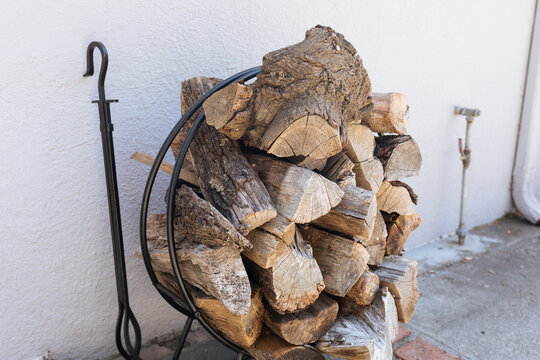 Firewood sits outside in a round holder