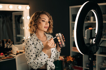 Beauty blogger showing eyeshadow palette