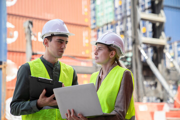 Female Manager technical using laptop to control the global freight through the network.