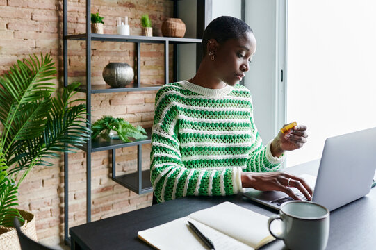 Woman using a credit card while shopping online