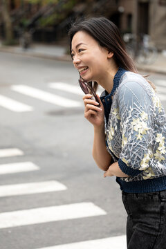 Happy woman laughing in street