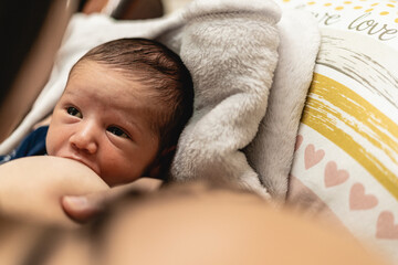 Unrecognizable mother breastfeeding her child