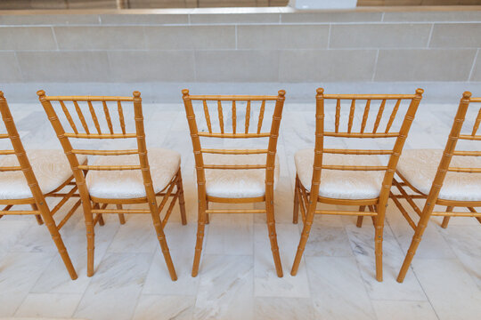 Fancy Wooden Chairs At A Wedding Ceremony