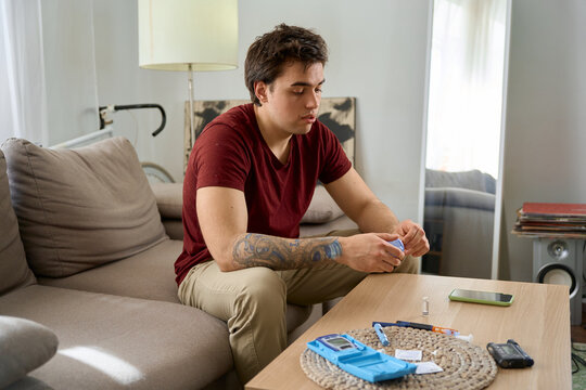 man with diabetes takes a finger blood test and does a routine home