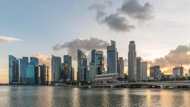 Singapore time lapse 4K, city skyline sunset timelapse at Marina Bay waterfront business district