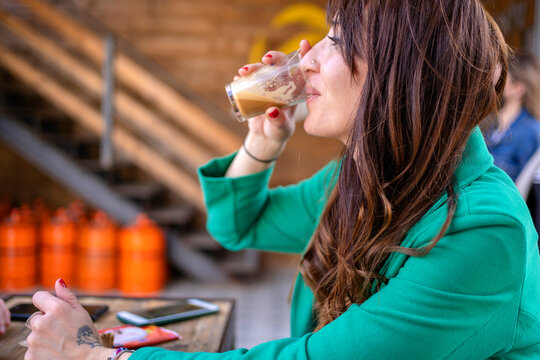 Brunette drinking coffee in cafe