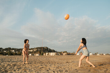 Energy friends playing ball on the beach