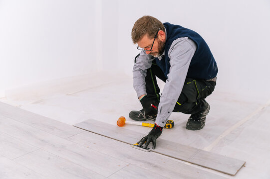 Interior designer installing floor planks