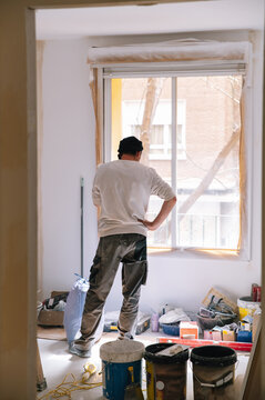 Anonymous handyman speaking on smartphone