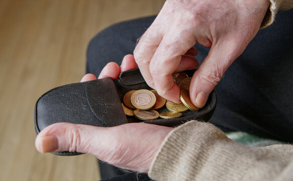 Senior man looking for money in his wallet