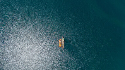 drone overhead of two tugboats parked together