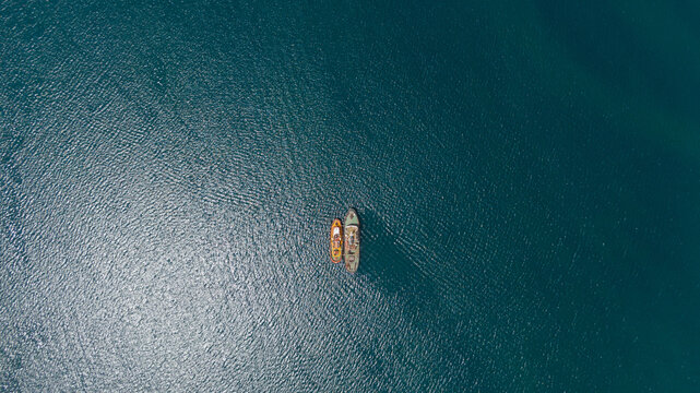 drone overhead of two tugboats parked together