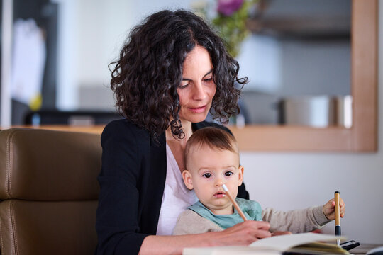 Mom with baby writing in planner