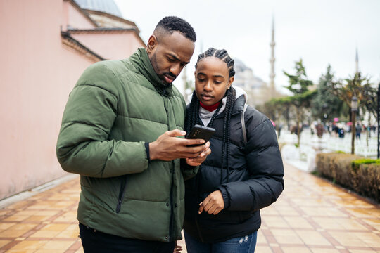 Tourists looking at the city map on the mobile