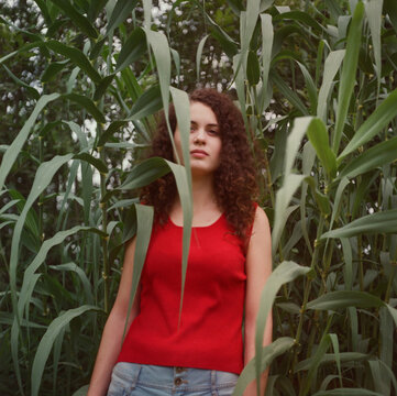 Young woman in a middle of corn plantation