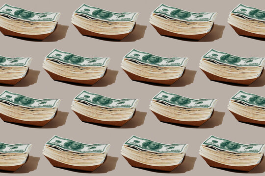 fake dollar bills in some paperboard trays