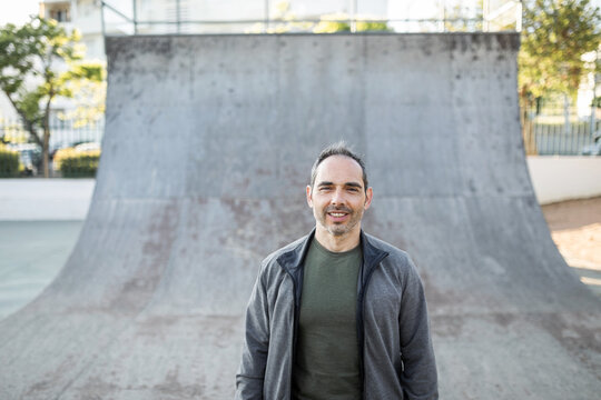 young man next to a half pipe in the city
