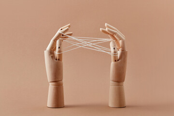 Mannequin's hands are playing a Cat's cradle game.