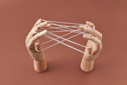 Figure from strings on wooden mannequin's hands.