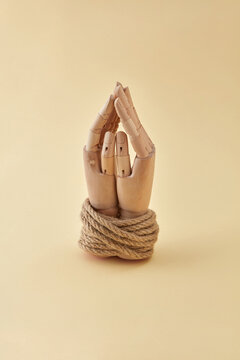 Dummy's hands tied with natural rope.