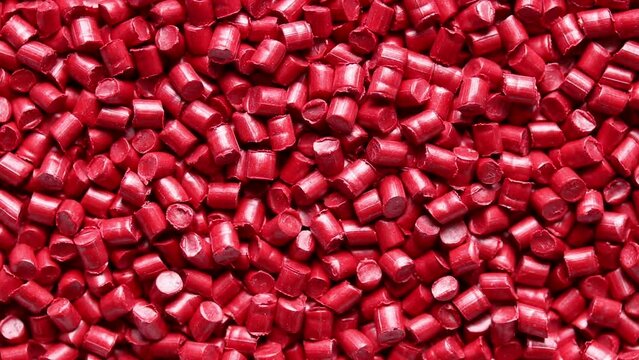 top view of red plastic resin ( Masterbatch ) rotation background