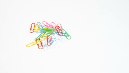 Obraz na płótnie Canvas stationery colored paper clips on a white background with a place for text